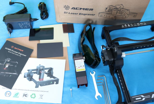 Unboxing the Acmer S1 6W Laser Engraver with all included accessories displayed.