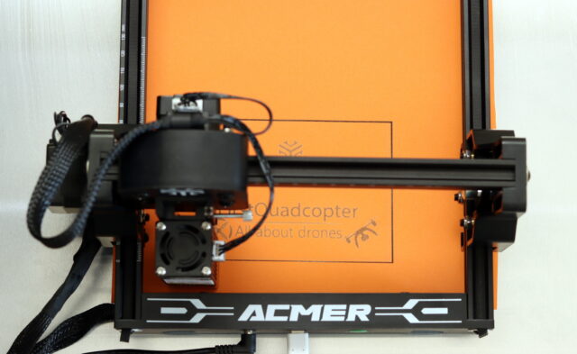 Test engraving of the Acmer and FirstQuadcopter logos on orange craft paper using the Acmer S1 laser engraver