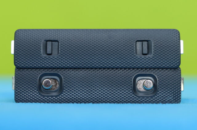 Close-up photo of K&F Concept X4 battery metal safety lockers designed to securely hold camera batteries.
