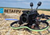 BetaFPV Pavo20 Pro O4 Pro cinewhoop drone equipped with DJI O4 Air Unit, shown on a hay bale ready for flight.