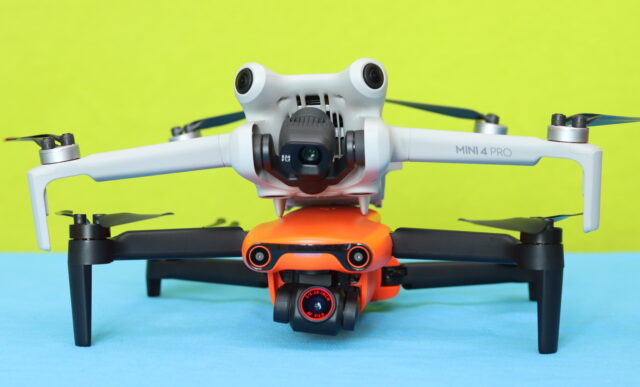 DJI Mini 4 Pro stacked on top of Autel EVO Nano Plus, showing a size and design comparison between the two compact drones.