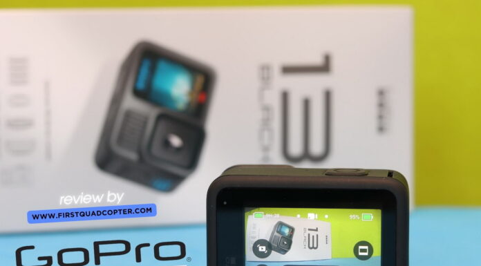 GoPro Hero 13 Black placed on a table during a hands-on review, with accessories and packaging visible in the background.