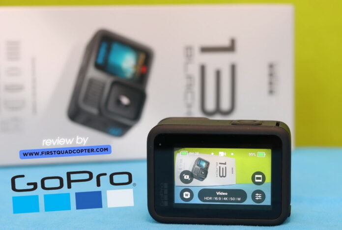 GoPro Hero 13 Black placed on a table during a hands-on review, with accessories and packaging visible in the background.
