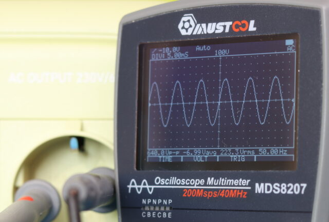 Bluetti Elite 30 V2 connected to an oscilloscope displaying a clean sine wave output.