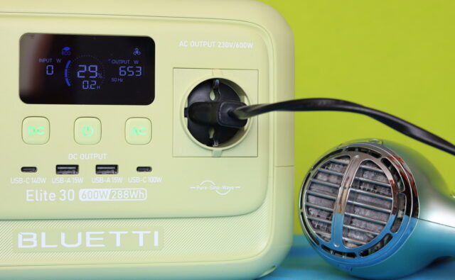 Bluetti Elite 30 V2 power station powering a hair dryer during a max-output test, with the display showing 653 watts.