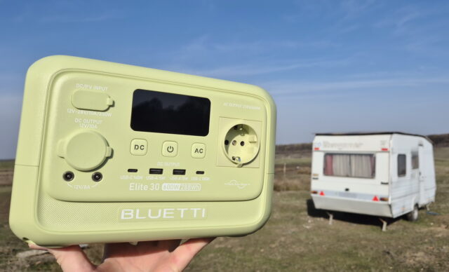 Portable power station connected to an RV at a campsite, supplying electricity during camping.