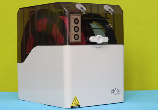 Chitu FilaPartner E1 filament box with two spools installed, showing filament outlet and secure closing knob