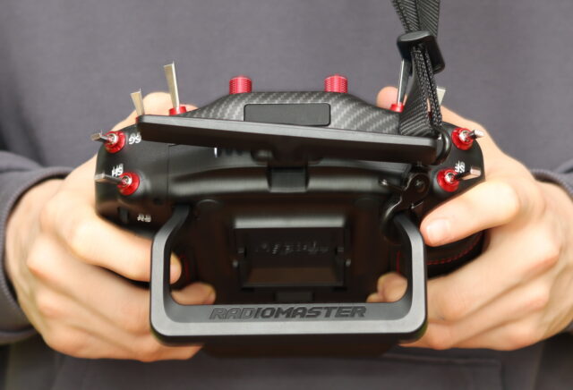 RadioMaster TX16S MK3 comfort test, held with both hands and supported by a neck strap during use.