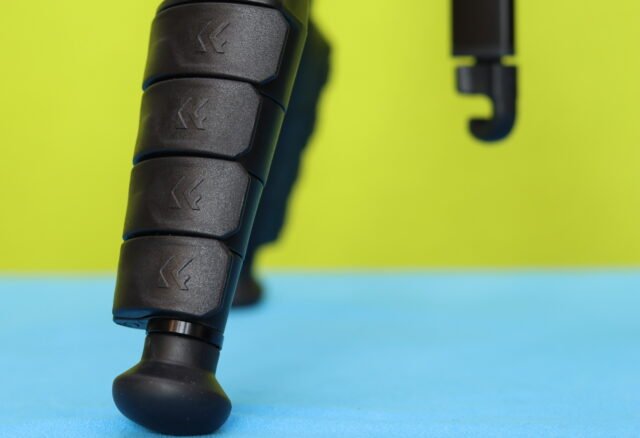 Close-up of the K&F CONCEPT 63-Inch Tripod leg section clamps and the center column counterweight hook extended below.