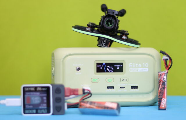 Bluetti Elite 10 portable power station connected to a drone battery, showing the device supplying power during charging.