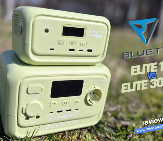 Side‑by‑side comparison of the Bluetti Elite 10 and Bluetti Elite 30 V2 portable power stations on a table with some accessories, showing both units clearly for a review photo.