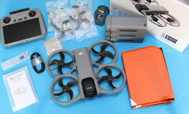 DJI Avata 360 Fly More Combo unboxing showing the RC 2 controller, three batteries, two-way charging hub, spare propellers, and landing pad.