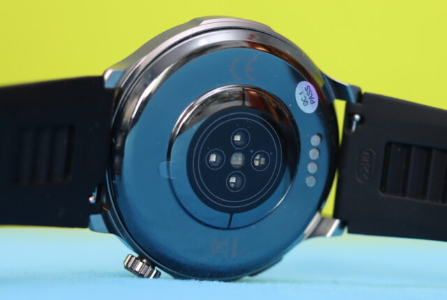 Back of the KKTICK Tank T6 rugged smartwatch showing the health monitoring sensors and magnetic charging contacts.