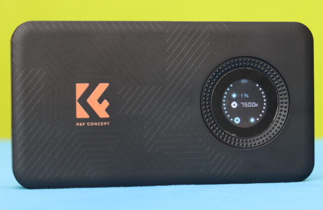 Close-up photo of the OLED screen on the K&F Concept LED video light displaying brightness level, color temperature, and RGB settings