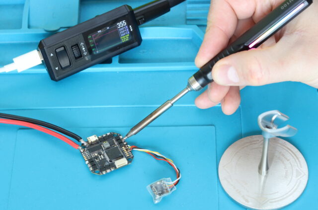 Miniware TS1M soldering iron repairing ESC and brushless motor wires on FPV drone electronics