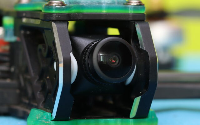 Walksnail Avatar HD Pro camera mounted on soft vibration-damping pads inside an FPV drone frame to reduce jello and improve video quality.