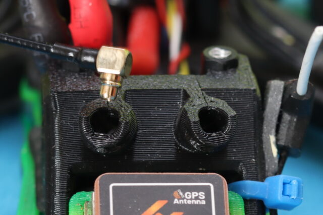 Close-up view of the Walksnail Avatar GT2 video transmitter showing its MMCX antenna connector mounted on the side of the unit.