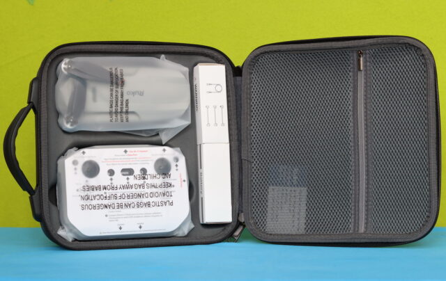 Inside the Ruko F11PRO 2 Plus carrying case showing the drone, remote controller, intelligent flight battery, charger, spare propellers, cables, and accessories securely stored in custom foam compartments.