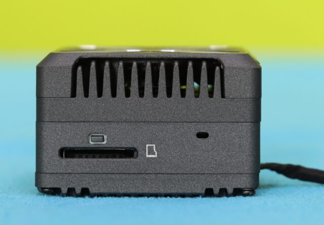 Side view of the Walksnail Avatar GT2 video transmitter showing the microSD card slot, bind button, and access points used for recording and system setup.